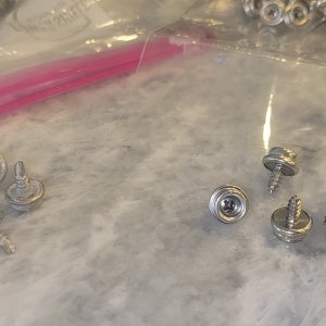 Replacing original self-tapping canvas snaps with new stainless.