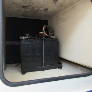 Battery under passenger seat