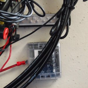 Sea Angel\'s Secondary AUX 6 ckt DC power block & 10x ground buss 1. The square block is the 12VDC Secondary AUX 12 VDC ATC fuse holder type Power Panel without ground strips and quick connect 'tabs' for the loads. 
The other end of red lead is connected to the 12VDC input connection (stud) of the Main Aux, 12 ckt  fuse panel w/ ground strips.