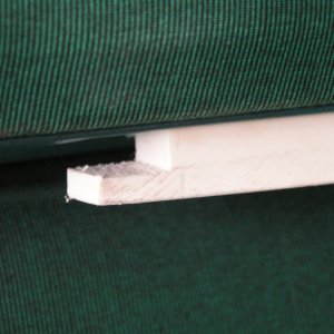 Notch to hook under drywall screw, 1 on each side (front/rear) towards wall end of seat