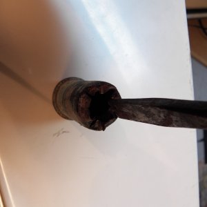 Then you tap it out and into the splash well.  Both of the drains had a skim coat of caulking and there was no balsa damage.