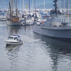 Catman's Bambina "doing what he can, just because he can", cruising out past the "Olympic Venture" an active duty Navy tender moored "mostly" at JWM.