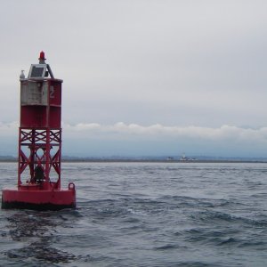 New Dungeness Bouy and Light house in the background. Almost too cloudy to see the Olympic Mountians.