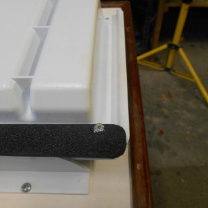 The latch is made from a piece of stiff plastic and three tiny bolts. Actually, glue would have taken the place of two bolts, but I had the bolts.  Pic is of the assembly up-side-down on the bench.  It is in the locked position.