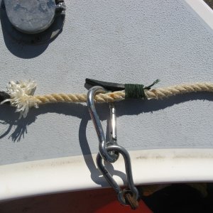 6/29/2012. Homemade buoy latch on my anchor line in the "captured" position. Anchor/chain to the left and hangs on the latch after pulling the anchor.
Latch is made from a nylon boat cleat with the base cut off.