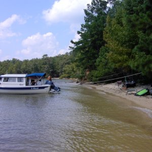 Anchor buddy deployed pulls boat away from shore. Pull stern line and budy streeeeeeetches so you can step off on the beach.