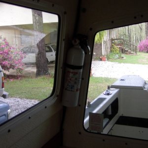 Use lower screw in outside grab rail to hold Fire extinguisher mount here. No new holes.