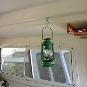 Eye hook replaces original screw. Can be used to hold line for drying towels at anchor. Eye hook $1.10, Kerosene lamp was $2 at the dollar store.