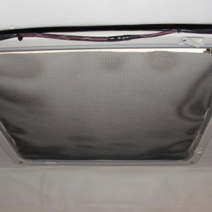panel of heavy coated fabric between screen and hatch glass keeps the light out on those summer mornings.  Also keeps out the light from those bright dock lights at marinas.