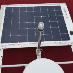 Removable 170 watt panel is spaced up from an aluminum sheet with felt dots and silicone the angle is bolted to the arch with U bolts and also unbolts from the panel for storage. I moved the anchor light back and made it foldable so I can stow the dinghy on the cabin top and also not shade the panel. (Aluminum has to have all the surface sanded down to remove mill scale so it doesn't pit corrode near salt)