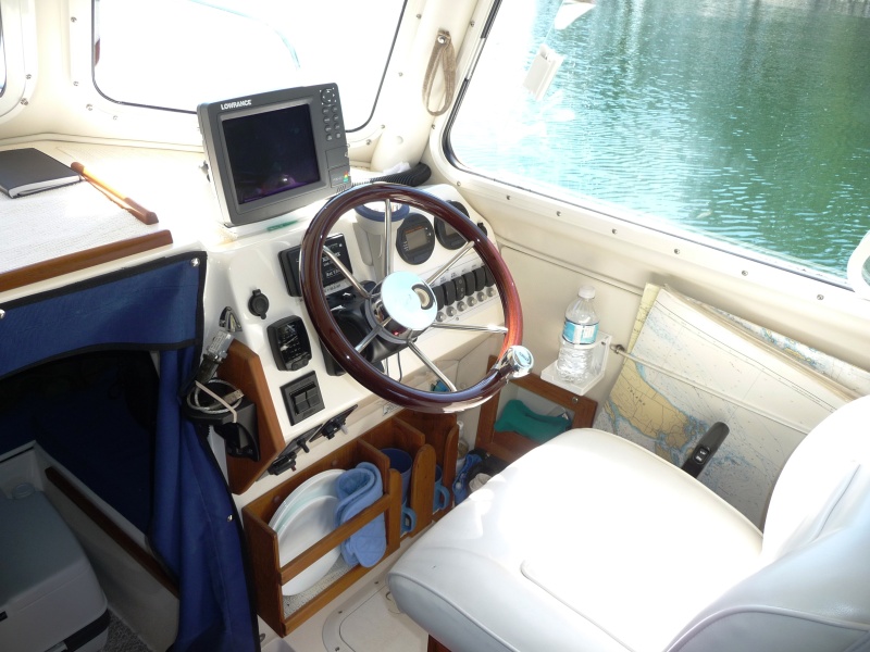 22. Dish and cup storage.
The teak to the left of the helm and above the dish rack is to hold the "www.RAM-MOUNT.COM" laptop computor bracket. You can sort of make out a part of the black "RAM" computor bracket and the "Lorrance" GPS plugin for the laptop. We use "Nobletec" Software for navigation when exploring higher up the British Columbia Coast.
