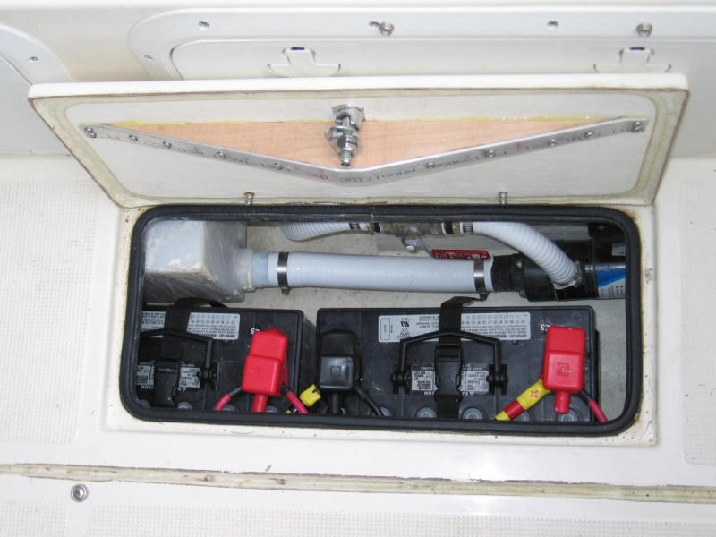 Batteries are installed below the deck hatches to keep weight low and free up storage space in transom - house bank shown.  Solenoid operated battery switches are remotely controlled from the helm station.  Truss mounted to underside of deck hatch improves seal by  preventing ends of hatch from springing upwards.  The truss is designed to bend the ends of the hatch downward about 1/16" which flattens out when dogged closed.