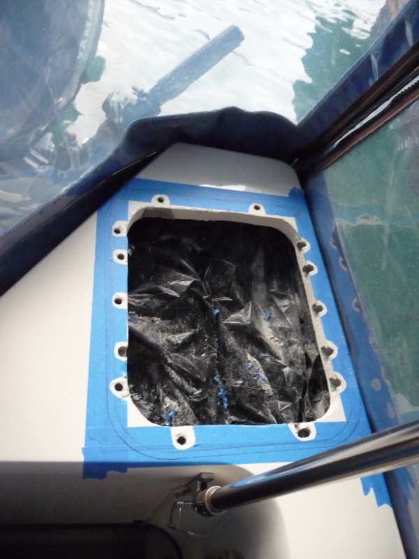 Black plastic bag to keep lazerate contents clean.
Blue painters tape to protect gel coat, mark out peremeter for inside and outside of hatch cover.
