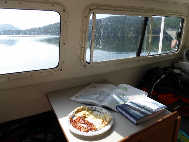 Breakfast and reading - The Curve of Time and the Dreamspeaker cruising guide