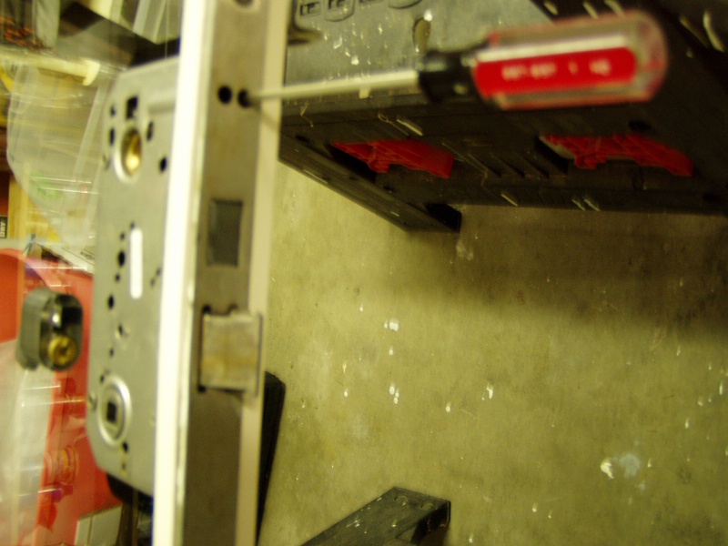 Dead bolt is removed  by loosening two flat blade screws deep inside the lock frame.  Do not remove the screws all the way, just enough to get the dead bolt out.