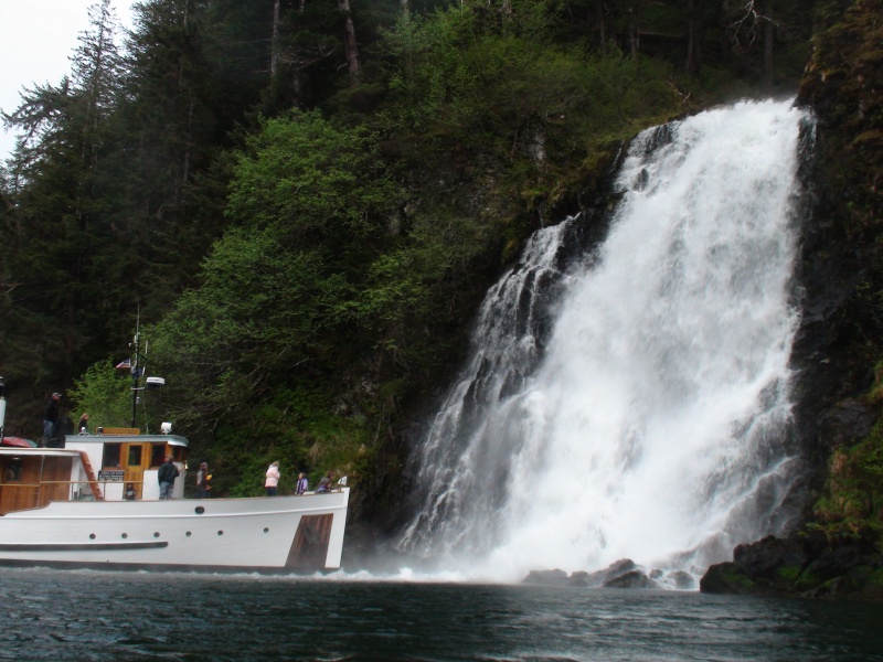 Discovery nosing into the Red Bluff Bay main attraction waterfall