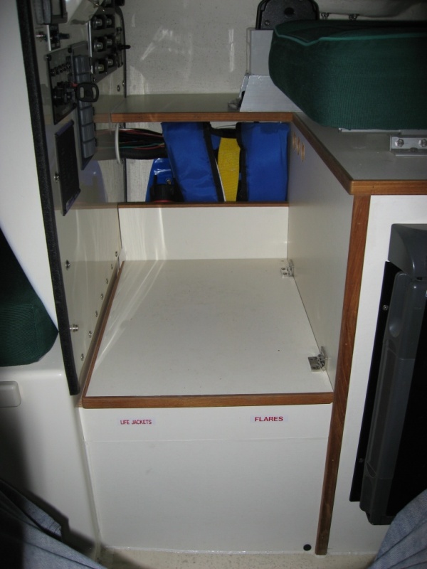 Foot rest raised 2-1/2" - Skipper's primary life jacket stored in side pocket.