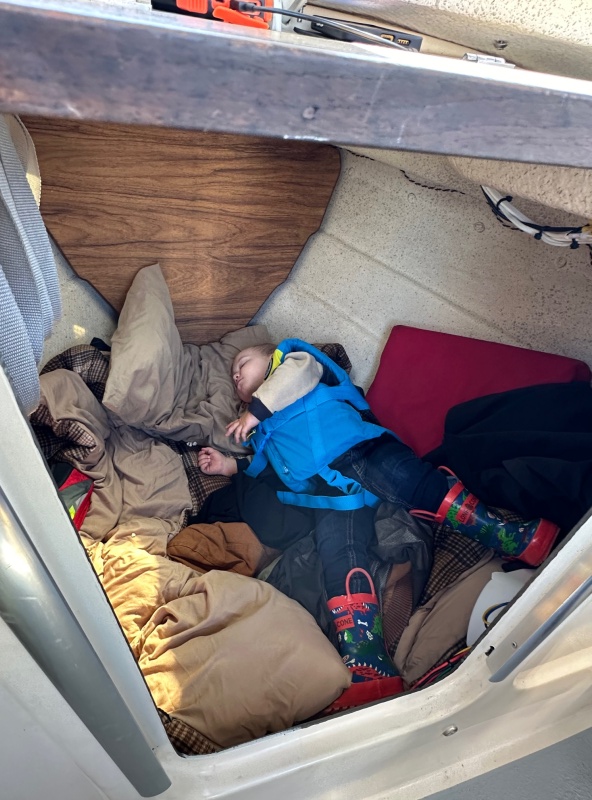 Grandson taking a nap up front in our 16' Angler!