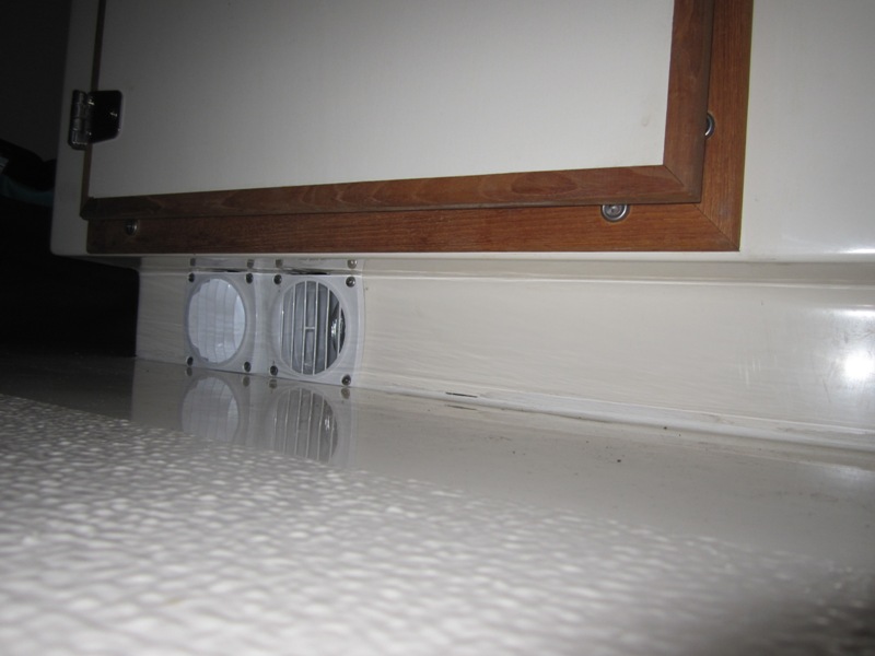 Heater outlets in toe kick under helm seat