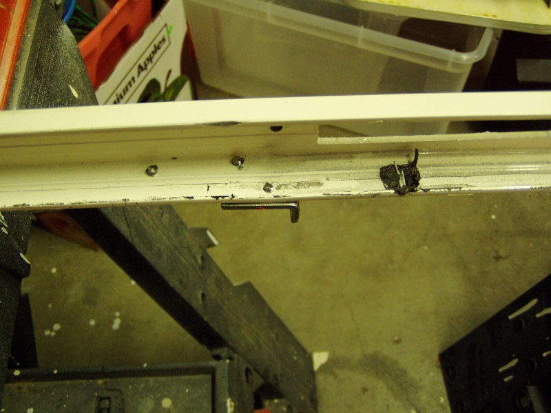 I think the two screws used to install the door holder may have caused the window to shatter.  I ground them down so they would not contact the edge of the new window.