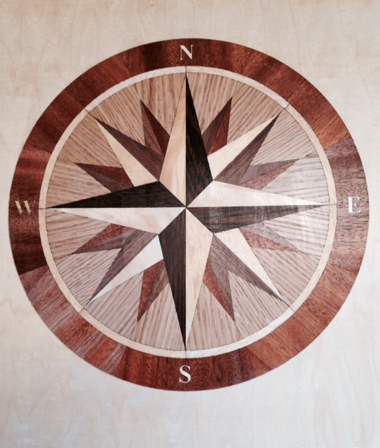 Inlay is 1/8\" thick mounted on a piece of 3/8 marine plywood. It is made of 4 different types of exotic hardwood.