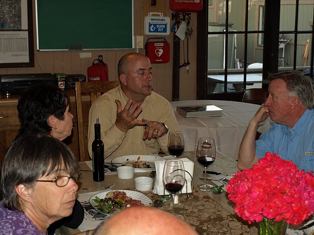 John explains the finer points of boat handling to Jim as Susan comtemplates his analysis.