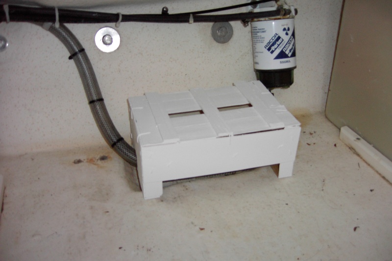 My first bilge cover was so heavy duty it could double as a trailer chock block. Now I have to put the boat on a diet. Check your trash can for one of these. This is one of those boxes that tangerine oranges come in. Ultra-light weight yet strong enough to protect the pump. My spare parts box is a tackle box that rides on top of the cover. Then the space gets filled with camping stuff.