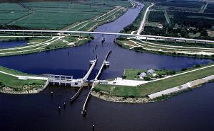 Port Mayac Locke: Lock chamber:56'x400'- Vertical lift: Diffenence between St. Lucie Canal water level and Lake Okeechobee 1/2' to 2' (sometimes it is a "pass thru")- Discharge capacity 14,800 cfs(cubic feet per second)Operates daily 6:00A to 9:30P-Marine VHF radio Channel 13-Located at Okeechobee Waterway 
statute mile 39.0