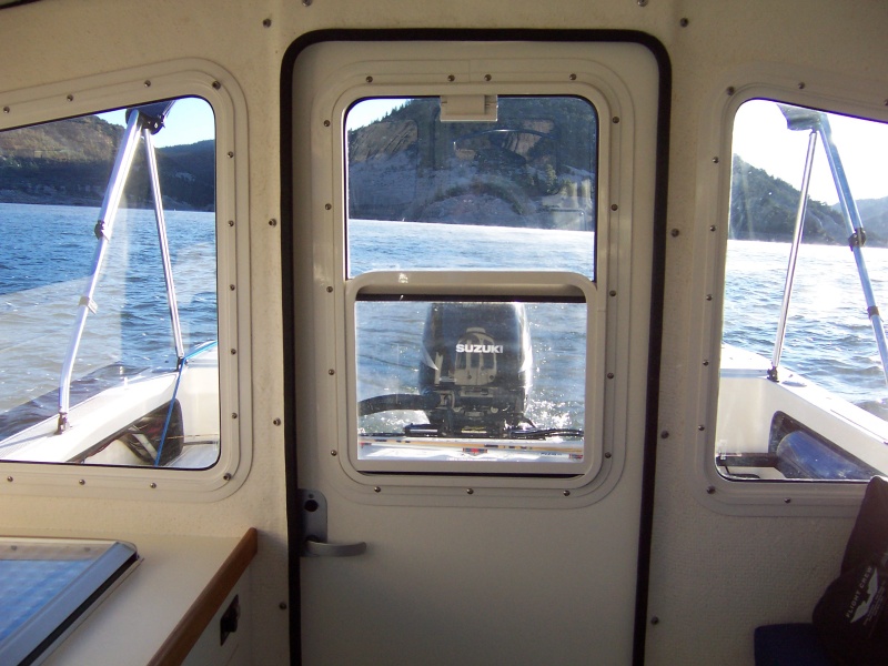 Rear door with sliding window and screen.