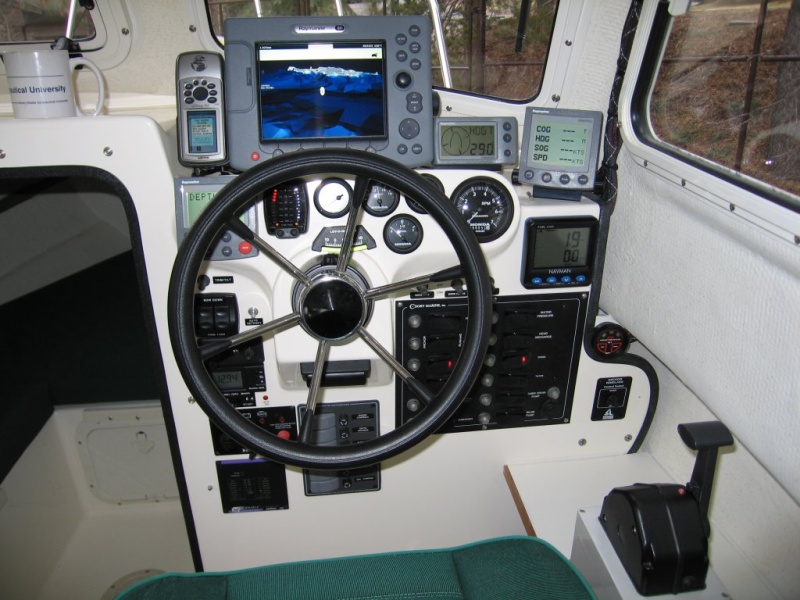 (Sea Skipper) Raymarine E80 Display with redundant handheld GPS to port & 2nd fluxgate compass to starboard.  Ray ST60 Graphic far right frees up space on main display normally devoted to data.