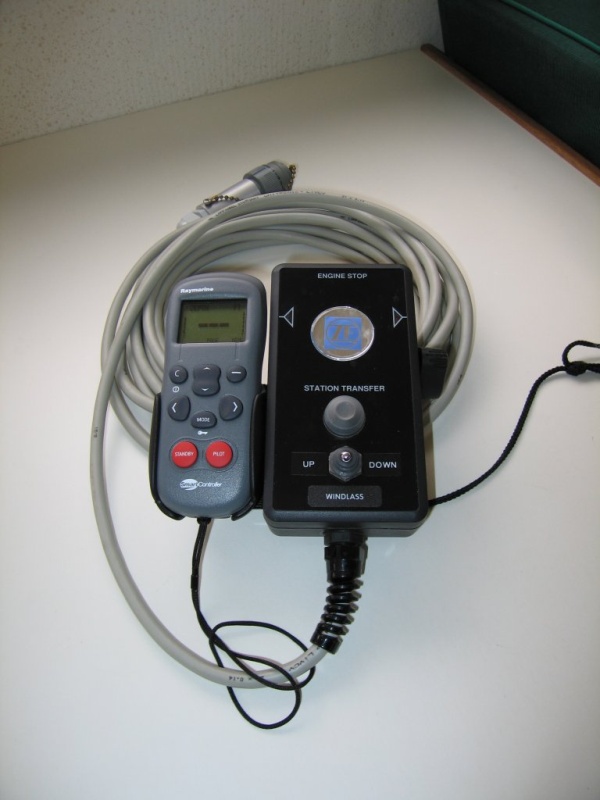 (Sea Skipper) Remote control for main engine throttle, shift and windlass on 25? cable.  Wireless autopilot and data display attached to side.  Lanyard to right side of control is attached to a magnetic kill switch.  The other end should be attached to me!