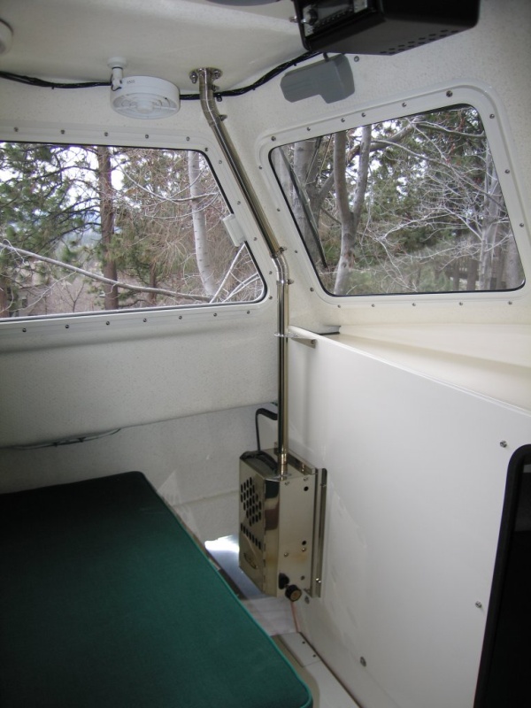 (Sea Skipper) Taylor?s pressurized kerosene heater, no electric power required - utilizes 1? flue.  Fan mounted aft of flue can be aimed to direct a warm blast of air clear across the forward windows for demisting.