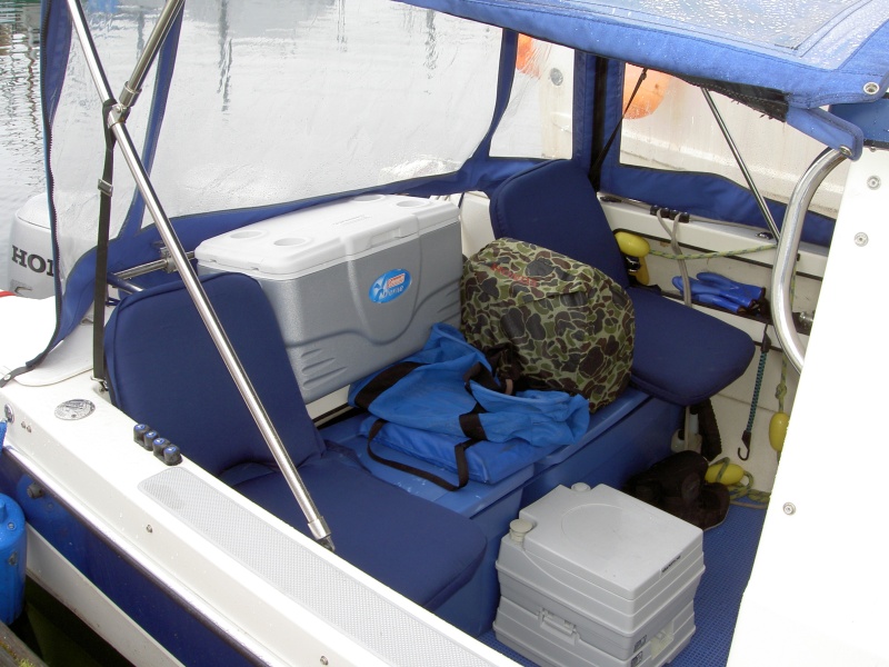 seating in the cockpit. the Honda 2000 generator sits & runs from where shown.  Has worked perfectly through many gallons of fuel from this position.  The blue containers they sit on hold 48 gal of fuel in 8, 6gal jugs. The chest rides there without ice.