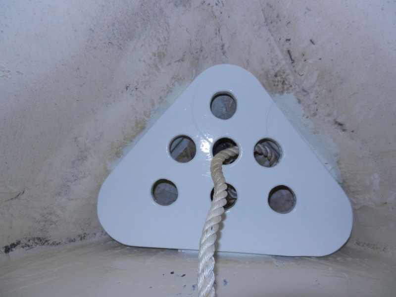 Shelf sits on cleats.  It has been thoroughly epoxy coated, then painted. Has holes for drainage.  Bitter end of rode tied off below.