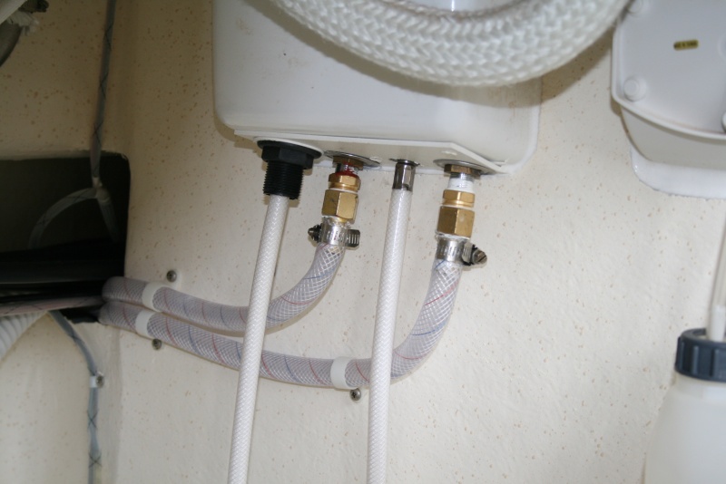 Shower hoses (under galley cabinet) showing new fittings