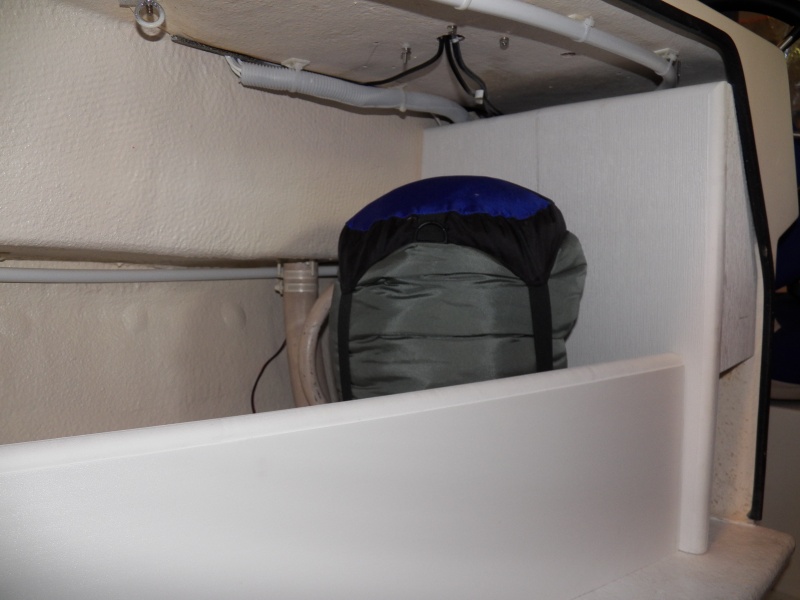 Sleeping bag in the cubby.  I'm planning on using the flat panel to mount my flare gun kit and a second fire extinguisher.  The "exposed" wiring that is left is mostly in white conduit and would now be very difficult to snag.