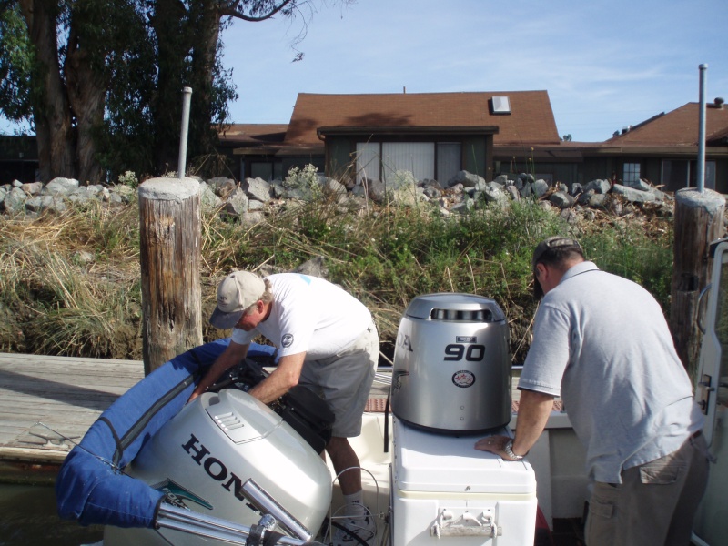 Steve (Dora Jean) doing a little on-the-water maintenance on Dinner Belle II.