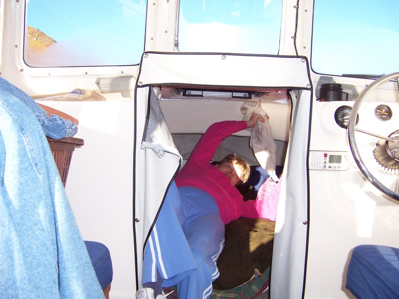 Sue wipeing condensation off v-berth ceiling.