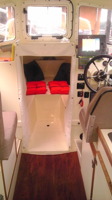 Tan Cuddy Cushions stored in home during winter. Synthetic wood flooring for wet environments provides extra insulation, eliminating the wet carpet issues.