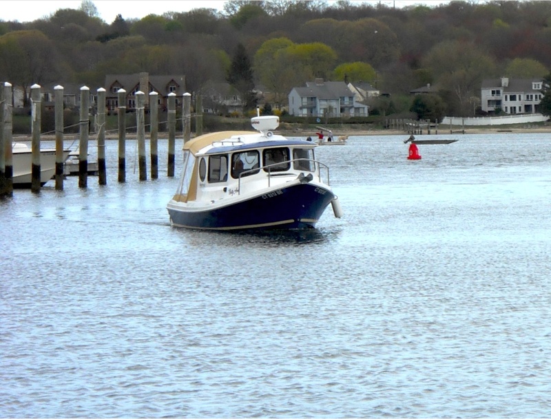 The Betty Ann arriving at its new home in Connecticut at Port Niantic. What great lines!  Note: If the port window looks kind of odd, it's because it is a piece of plexiglass taped to the hull with white shrinkwrap tape.  While Les was trailering our boat cross country, a passing vehicle threw up a stone, which crashed through 3/8" tempered glass!  What are the odds of that happening, and to such robust glass?   So it's going to be a few weeks before the glass is replaced.