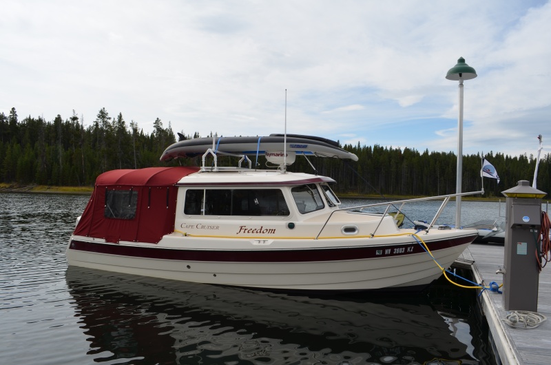 The kayak weighs a total of 32 pounds, spread between the rack and radar dome.  The bow section rests on the radar dome but does not touch the anchor light or VHF antenna.