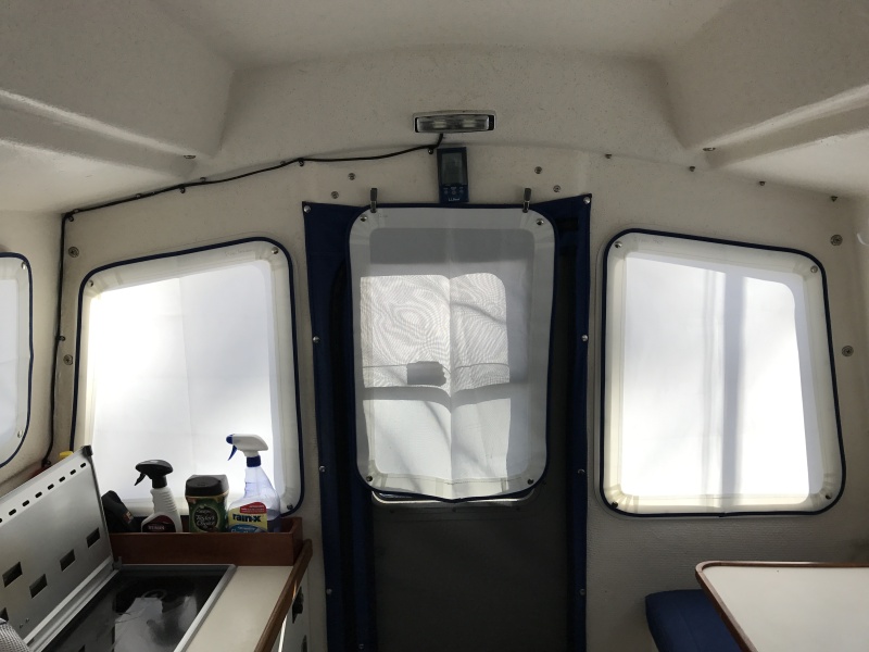 Translucent window covers for all windows and full length zippered screen in doorway.