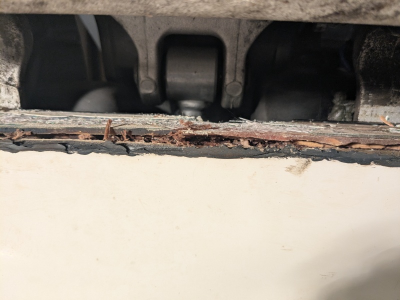 Transom beneath main motor mount, with cap removed. Rotten wood picked out for investigation.