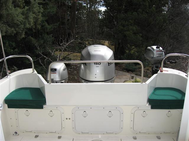 Transom shield - the rail is removable. Note the third hatch installed in the middle of the transom storage area which improves access.