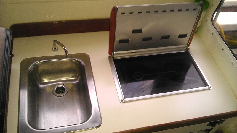 Wallas stove and stainless sink - Lid up for cooking, lid down and fan converts oook top to cabin heater. Very efficient heating and cooking unit.