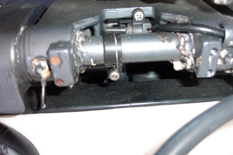 You can see the crack just above the screw.  The wire holds it together.